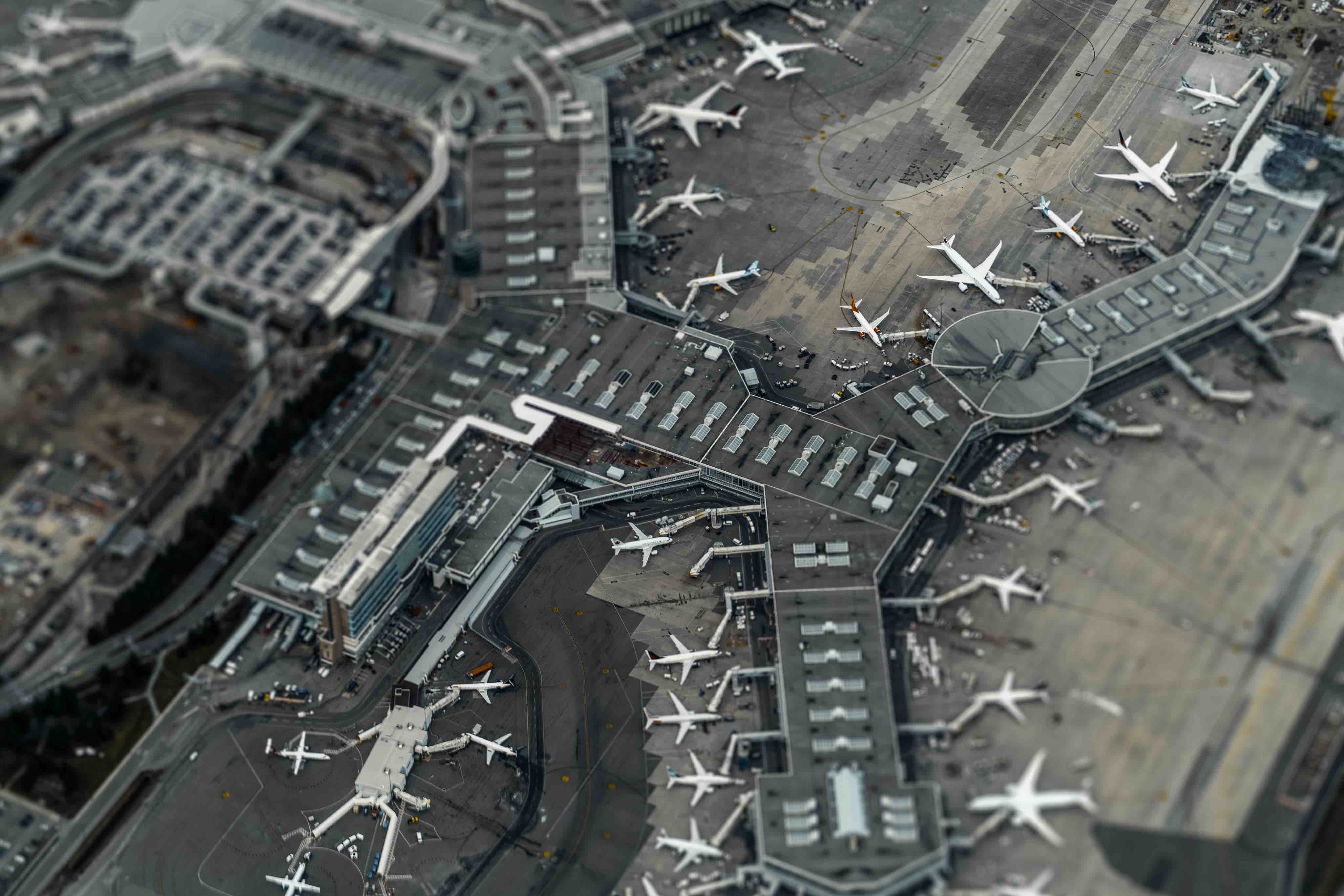 An aerial view of an airport with many airplanes.